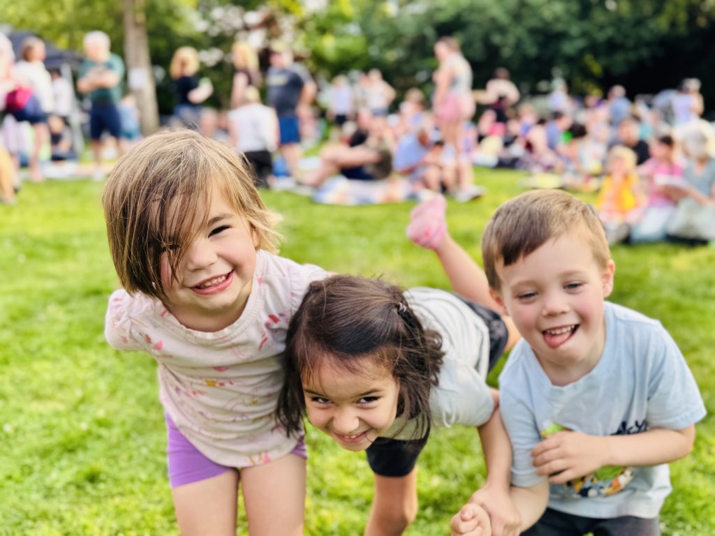 three preschool kids playing outside